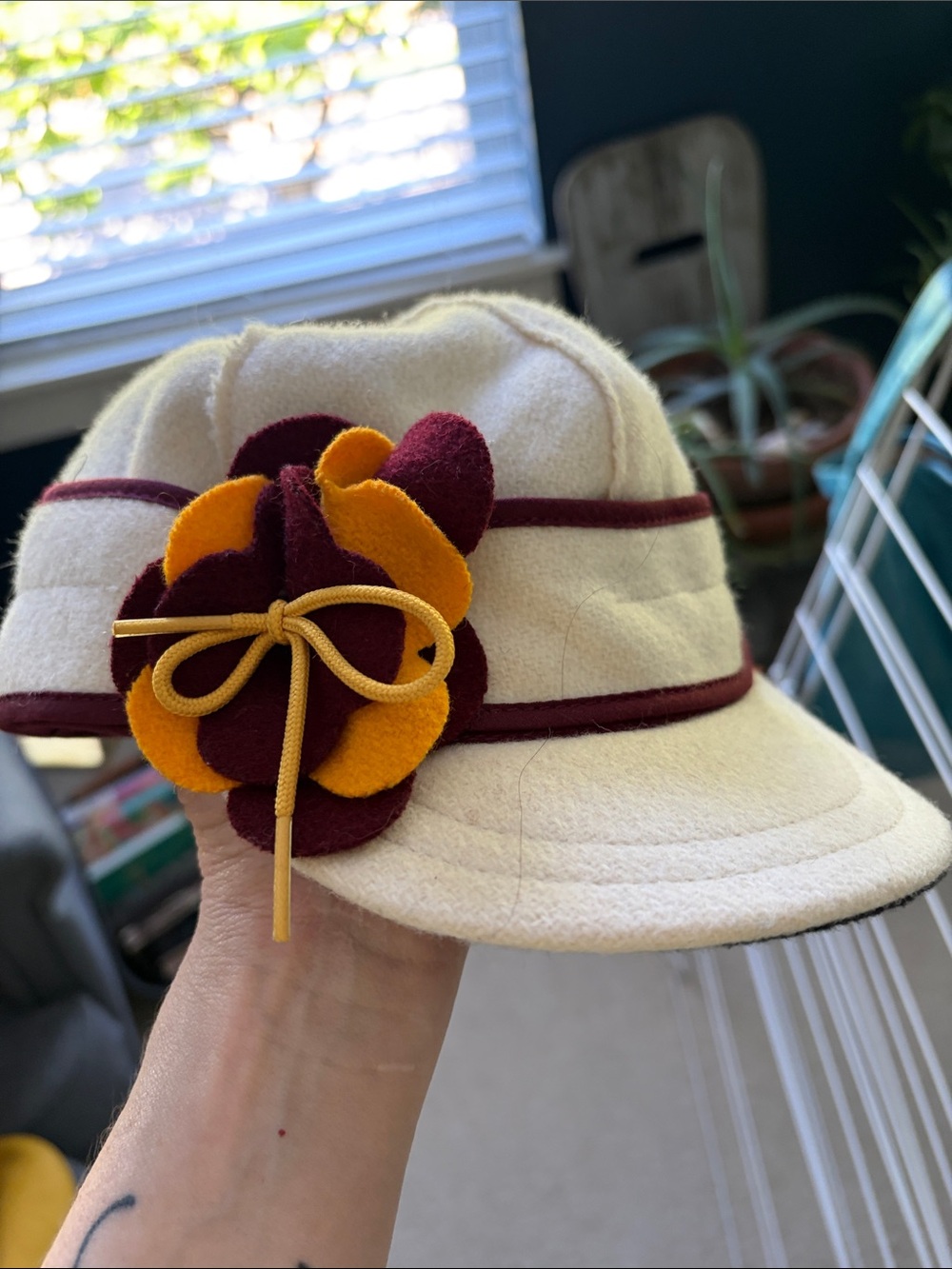 Cream Stormy Kromer Wool Ladies Cap with Burgundy Trim and Gold-Yellow Flower